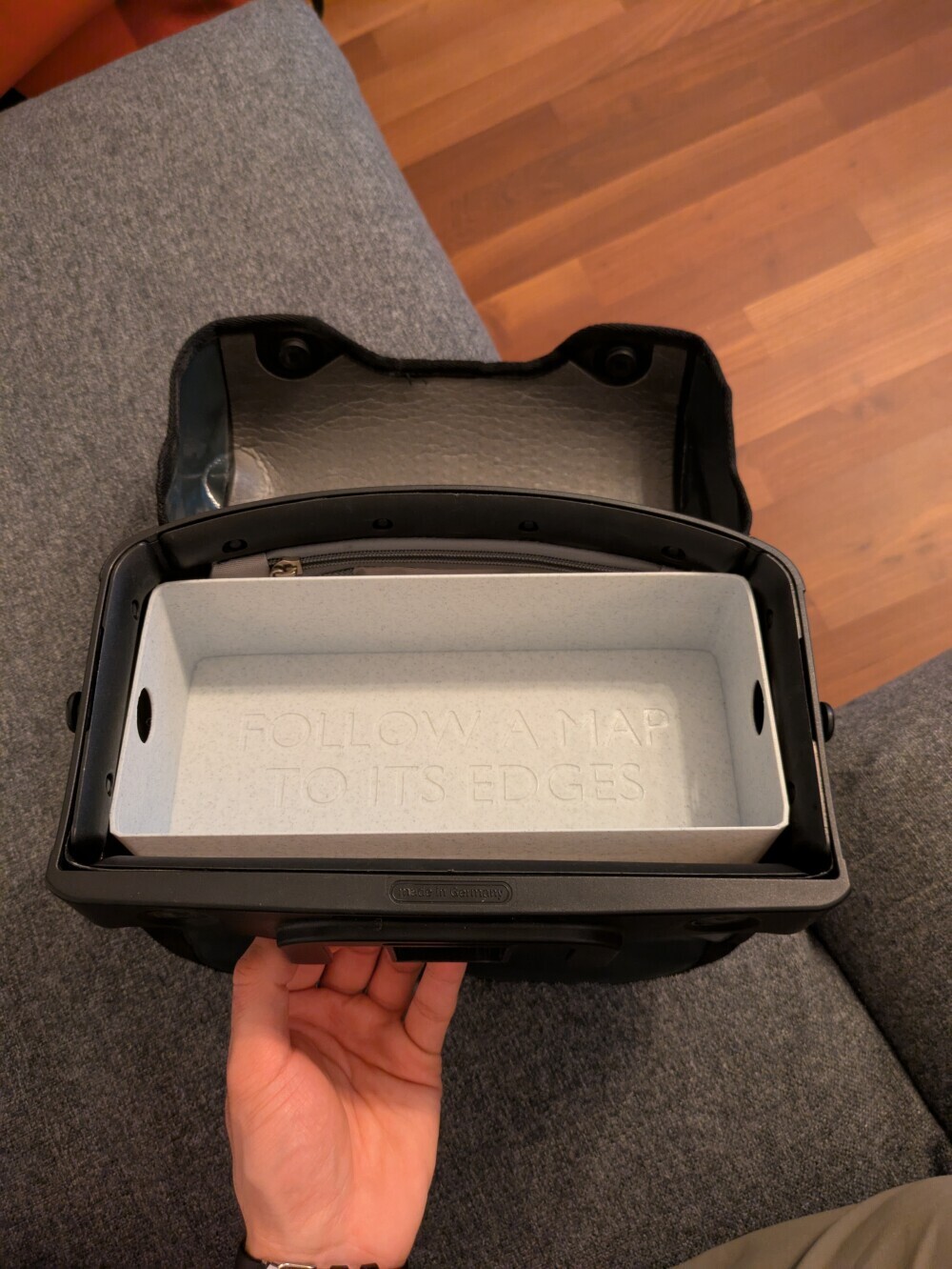 The tray deliberately leaves gaps at the front and back for tall items like my notebook