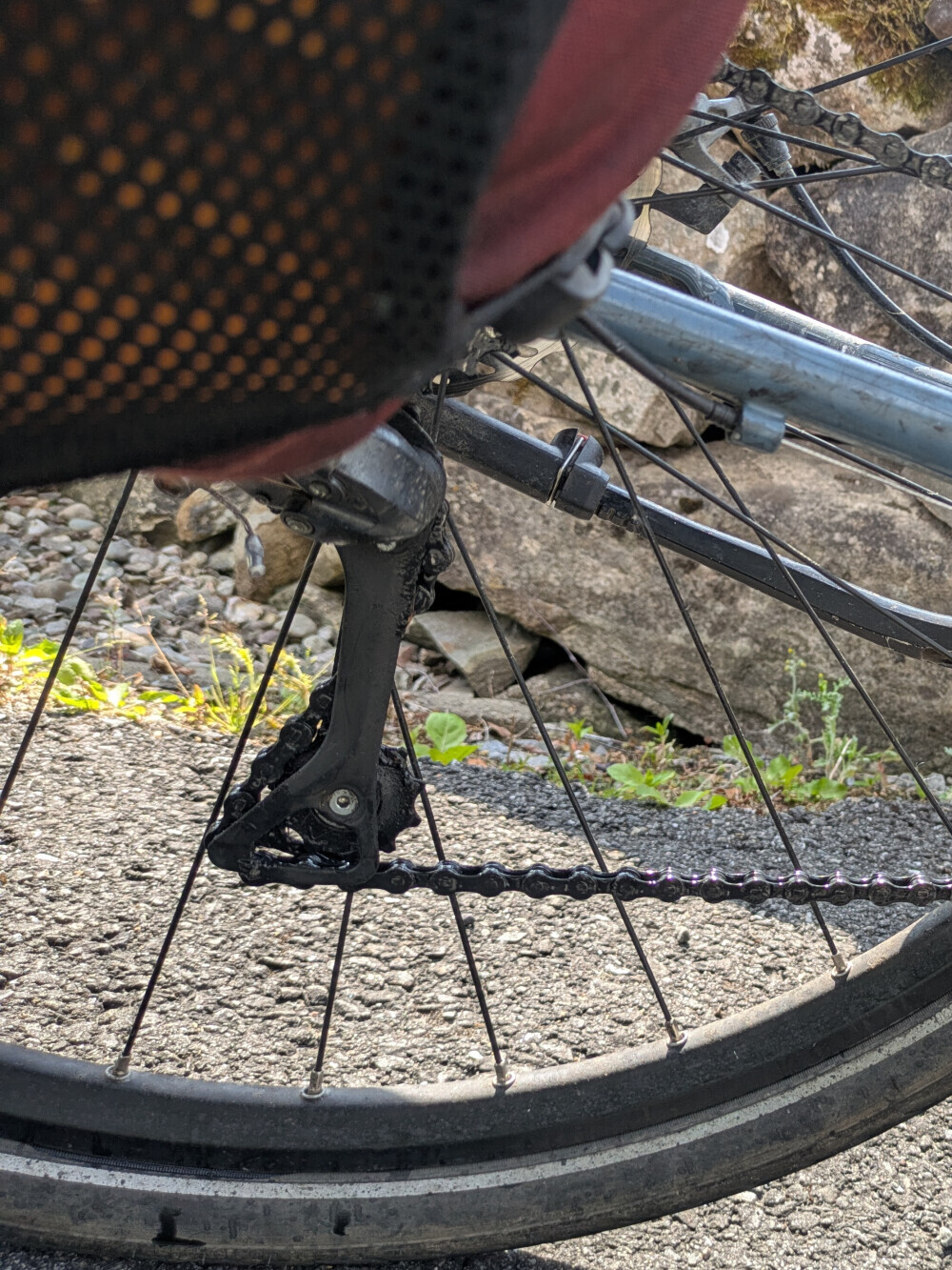 The chain should be wrapped around that lower cog, not out to the left