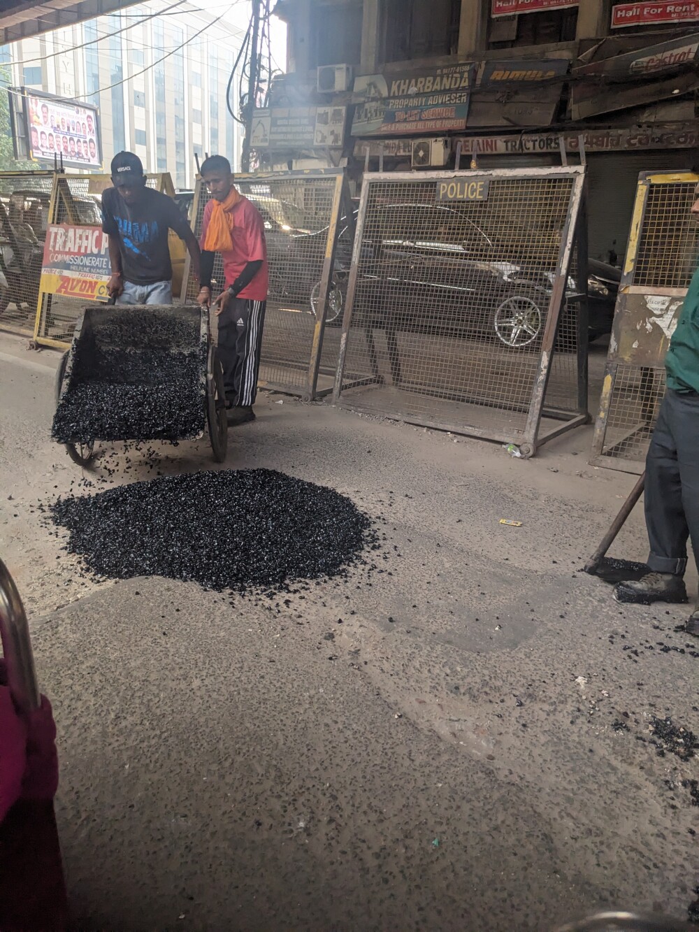Filling potholes in the middle of traffic